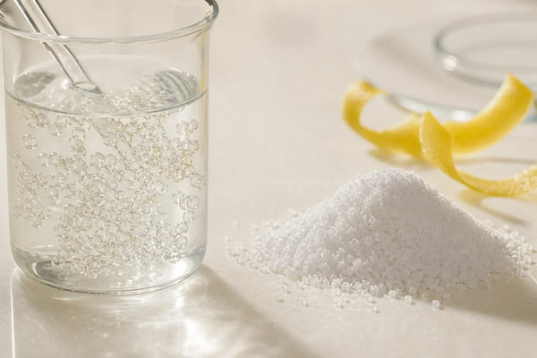 Liposomal spheres and crystalline ascorbic acid compared on an ivory laboratory surface