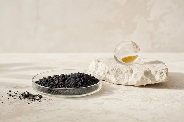 Close-up of raw activated charcoal granules and powder showing porous carbon texture
