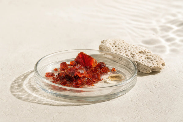 Magnified view of reddish-orange astaxanthin pigment from microalgae, representing the raw carotenoid compound