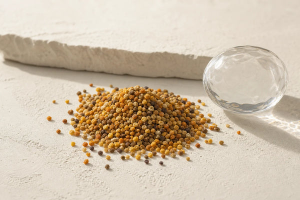 Close-up of raw bee pollen granules showing natural color and texture variation