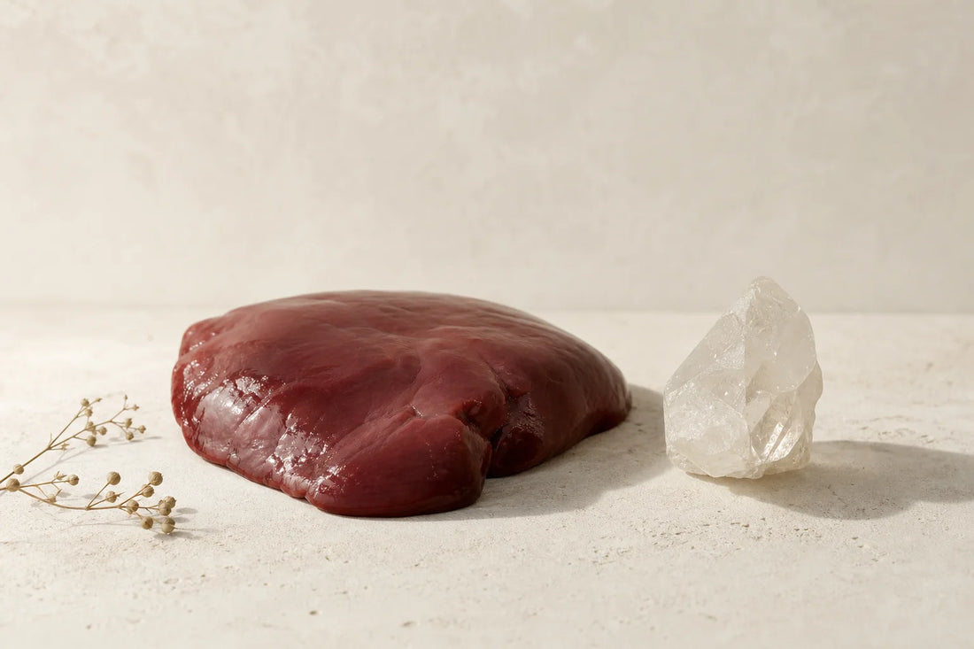 Raw beef liver tissue on a neutral background, representing the food-composition subject of the research review